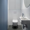 Simple lavatory with blue wall Royalty Free Stock Photo