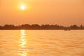 Simple life, golden light shines down around the Mekong River, fishing boat returning home in the evening. Don Khon Island, Si Royalty Free Stock Photo