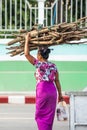 Simple life style at Tarchileik market, Eastern Myanmar. Women burmese in traditional clothing carrying a bundle of firewood on