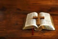 a simple light oak colored cross on a open bible .