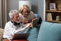 Simple living. Elderly retired couple enjoying their retirement, reminiscing entertaining in their warm home. Senior people Royalty Free Stock Photo