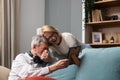 Simple living. Elderly retired couple enjoying their retirement, reminiscing entertaining in their warm home. Senior people