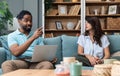 Simple living. Young couple man and woman at home working on laptop, reading book, talking and argue, making fun. Real life Royalty Free Stock Photo