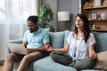 Simple living. Young couple man and woman at home working on laptop, reading book, talking and argue, making fun. Real life Royalty Free Stock Photo