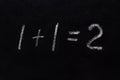 Simple math equation 1 1 2 written school board chalk. Blackboard equations one plus one equals two written black board