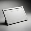 A simple modern light colored picture frame with a stand displayed at an angle on a white background isolated on white background Royalty Free Stock Photo