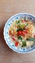 Simple noodle soup with the addition of tomatoes and mustard greens and a sprinkling of chili powder and fried shallots.