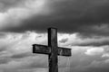 Simple oak wood cross, gathering dark storm clouds in the background Royalty Free Stock Photo