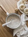 Simple oatmeal porridge in a saucepan on a wooden table, top view. Delicious healthy breakfast Royalty Free Stock Photo