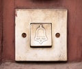 Simple old doorbell, rectangle door bell switch with a bell symbol on it, object macro, extreme closeup, front view, frontal shot Royalty Free Stock Photo