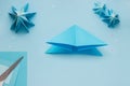 Simple origami 3D Christmas tree made from blue paper. Step by step instruction, step 7