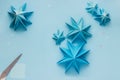 Simple origami 3D Christmas tree made from blue paper. Step by step instruction, step 18