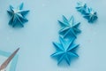 Simple origami 3D Christmas tree made from blue paper. Step by step instruction, step 17