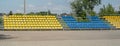 Simple outdoor vacant empty stadium stands wide panorama shot, nobody, no people, small downtown sports arena outdoors venue