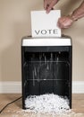 Paper vote being shredded in an office shredder