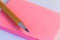 Simple pencil and paper note. Closeup pink paper note of sketch with wood pencil. Royalty Free Stock Photo