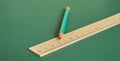 A simple pencil and ruler lie on a plain green background. Close-up Royalty Free Stock Photo