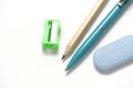 Simple pencil, sharpener, ballpoint pen and eraser white background. Royalty Free Stock Photo