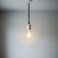 A simple pendant light fixture hangs from the ceiling, featuring a transparent Royalty Free Stock Photo