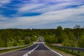 Simple photo of a beautiful road and forest in summer.