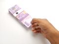 Simple Photo Conceptual, Top View Caucassian Right Man Hand Picking one sheet 10000 Rupiah Indonesia Paper Money at white Royalty Free Stock Photo