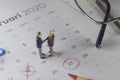 Simple Photo Illustration, Handshaking Mini Figure Businessman, Agree to doing something together at marked date