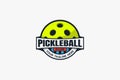 Simple pickleball club logo with a ball, ribbon, and tagline copy space