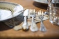 A simple picture of a table setting with dishes and cutlery and glass