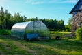 simple plastic greenhouse in countryside home garden