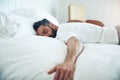 The simple pleasure of sleep. a mature man lying on his bed and sleeping.