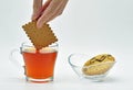 Simple pleasures dipping biscuit in tea Royalty Free Stock Photo