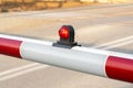 Simple rail crossing barrier red light, train crossing railroad station gate detail, closeup. Warning signal light on, object Royalty Free Stock Photo