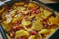 A simple recipe for food. Baked potatoes with red fish in the oven. Ready lunch on a close-up tray Royalty Free Stock Photo