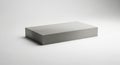 A simple rectangular concrete block rests on a plain white surface with subtle lighting Royalty Free Stock Photo