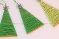 Christmas trees on a wooden table. Creative Christmas trees made of old cardboard box and cotton yarn. Recycled crafts Royalty Free Stock Photo