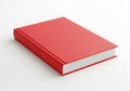 A simple red hardcover book resting on a clean white surface with pages visible Royalty Free Stock Photo