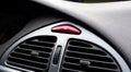 Simple red hazard warning lights button on car dashboard, triangle pictogram closeup, detail shot. Vehicle safety light alert Royalty Free Stock Photo