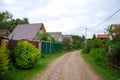 A simple rural dirt road in Russia. The road in the country village. Rustic landscape. The road in the village. Country Royalty Free Stock Photo