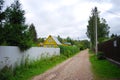 A simple rural dirt road in Russia. The road in the country village. Rustic landscape. The road in the village. Country Royalty Free Stock Photo