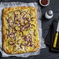 Simple rustic crispy pie with potatoes, cheese and red onion. Royalty Free Stock Photo
