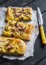 Simple rustic crispy pie with potatoes, cheese and red onion. Delicious lunch Royalty Free Stock Photo