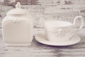 Simple rustic white and blue crockery, empty dishes. Large bowl, cup and porcelain jar with lid. Wooden background, shabby chic