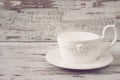 Simple rustic white crockery, empty dishes. A large cup of coffee in front angel. Wooden background, shabby chic, vintage Royalty Free Stock Photo