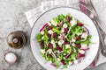 Simple salad with arugula, beans, soft cheese, onions and oil