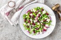 Simple salad with arugula, beans, soft cheese, onions and oil