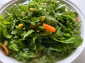 Simple salad with carrots French beans and spinach tossed with corn