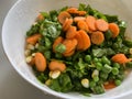 Simple salad with lots of carrots French beans and spinach tossed with corn