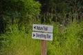 Sign giving simple directions with grass in the background