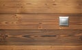 Simple silver coloured plastic light switch on wooden boards wall