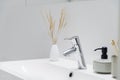 Simple silver tap in bathroom washbasin  close-up Royalty Free Stock Photo